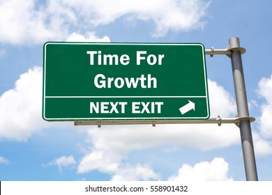 Green Overhead Road Sign With A Time For Growth Next Exit Concept Against A Partly Cloudy Sky Background.