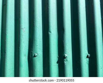 Green Painted Sun Drenched Corrugated Iron Panel Fence Detail