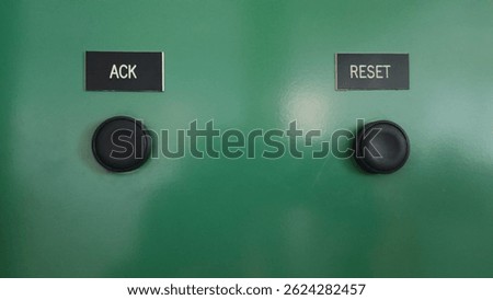 A green panel features two black buttons labeled 
