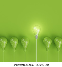 Green Pantone Light Bulbs With Glowing One Different Idea On Pastel Green Background. Minimal Concept. Top View.