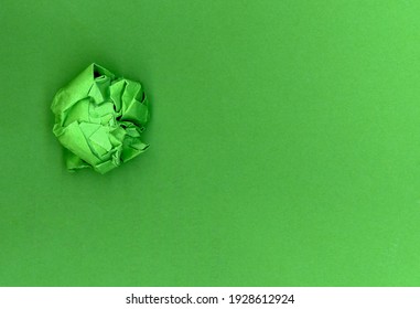 Green Paper Ball Over Green Cardboard Background