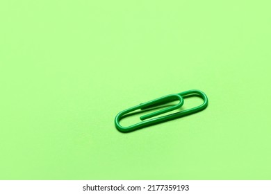 Green Paper Clip On Color Background