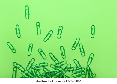 Green Paper Clips On Color Background