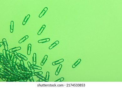 Green Paper Clips On Color Background