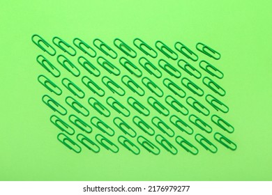 Green Paper Clips On Color Background