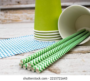 Green paper cups with green paper straws and blue handkerchief. Mention the sustainable party, replacement of plastic in people's routine and get-togethers for actions in support of the environment. - Shutterstock ID 2215721643