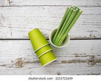 Green paper cups with green paper straws. Mention the sustainable party, replacement of plastic in people's routine and get-togethers for actions in support of the environment. - Shutterstock ID 2215721659