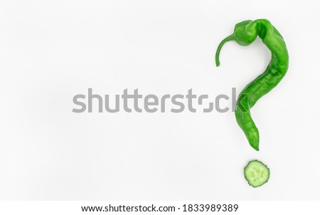 A green paper in shape of interrogation mark on white background with space for text. Vegetables and healthy eating. Make your choice concept.