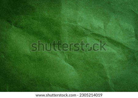 Green paper texture background. Abstract dark green surface for designs.