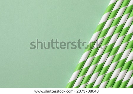Green paper tubes on a colored background