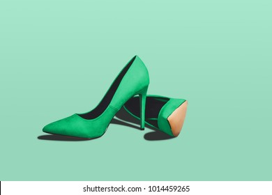 Green Pastel High Heels Isolated On A Bright Green Pastel Background. Fashion Concept, Catwalk. A Modern And Fashionable Shoe Store.