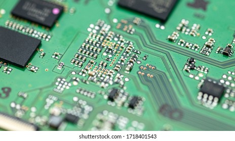 Green PCB (printed circuit board) close-up shot with a lot of electronic components
