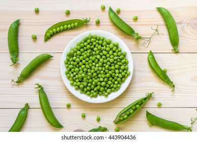 Green pea in bowl of top view on rustic wooden background with copy space, natural wooden table. Flat lay. 