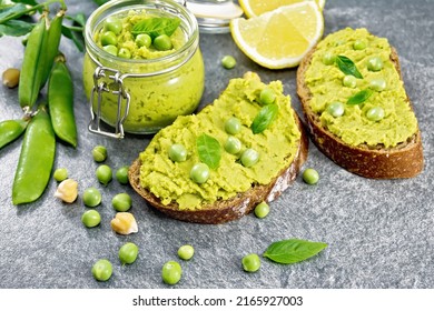 Green Pea And Chickpea Hummus Sandwiches, Jar Of Dipping Sauce, Pea Pods On Gray Granite Countertop Background