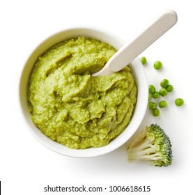 Green Peas And Broccoli Baby Puree In Bowl With Baby Spoon Isolated On White Background, Top View