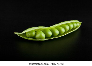green peas on a black background closeup