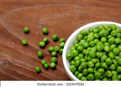 Green peas.In white bowl.On wooden background, table.Top view .Copy space