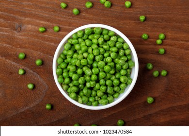 Green peas.In white bowl.On wooden background, table.Top view .Copy space