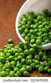 Green peas.In white bowl.On wooden background, table.Copy space.Selective focus.Closeup
