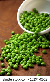 Green peas.In white bowl.On wooden background, table.Copy space.Selective focus