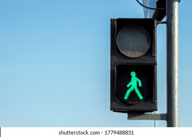 Green Pedestrian Traffic Light Against The Sky