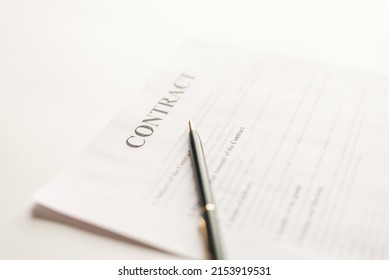 Green Pen And Contract Papers On White Desk