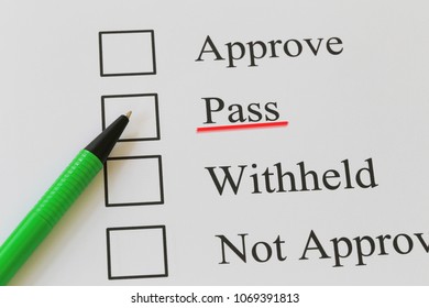 Green pen pointing Pass text and underlined in red color for design ideas for presenting in your work.