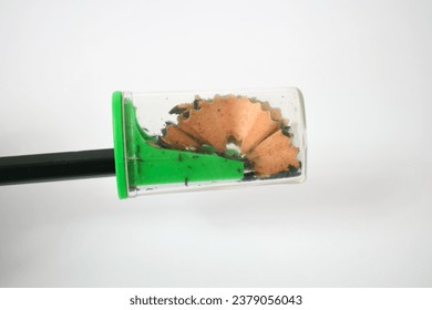 green pencil sharpener and dark green pencils on white background - Powered by Shutterstock