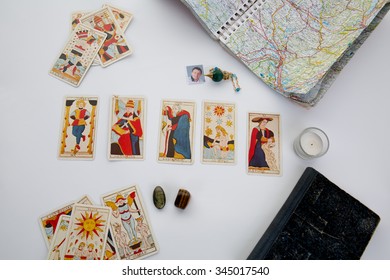 Green pendulum over a table with astrology chart and tarots cards - Powered by Shutterstock