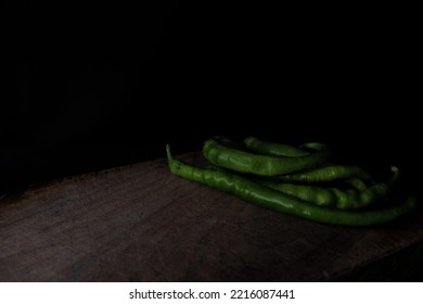 Green Pepper On Cutting Board In Low Light