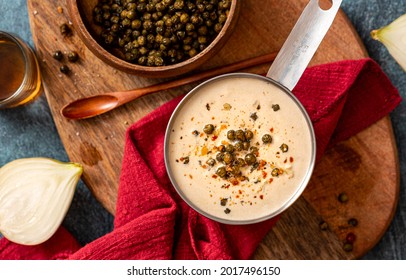 Green pepper sauce top view. Spicy creamy sauce with peppers, onions and brandy. Hot cream sauce for steak. - Shutterstock ID 2017496150