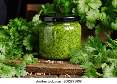 Green pesto with coriander herb on rustic wooden dark background, clloseup, copy space, italian dip food and dressing, homemade food concept - Powered by Shutterstock