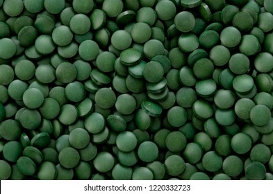 green pills,Spirulina tablets background