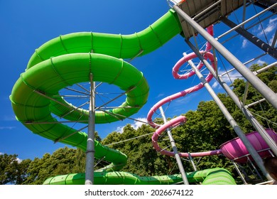Green and pink water slide in aquapark