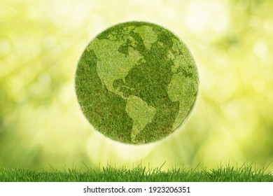 Green planet Earth with grass on green background - Shutterstock ID 1923206351