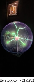 Green Plasma Ball Reacting To The Touch Of A Hand