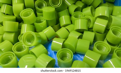 Green Plastic Bottle Cap Product, From The Injection Molding Machine Of The Manufacturing Department, In The Plastic Factory.