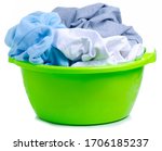 Green plastic bowl with laundry clothes on white background isolation