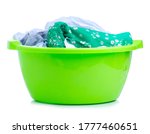 Green plastic bowl with laundry on white background isolation