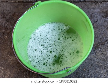 Green Plastic Bucket With Soapy Water To Clean