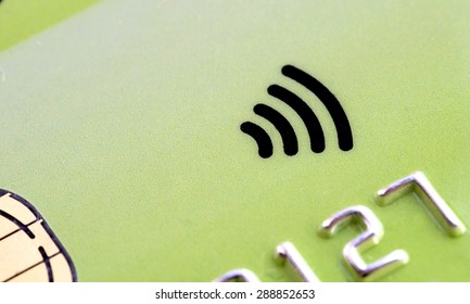 Green plastic  Credit card with contactless symbol electronic chip and money