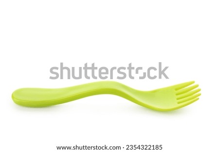 Green plastic fork for baby isolated on white background