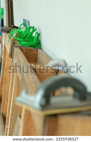green plastic rope lying on a wooden pallet standing with foreground and background defocused