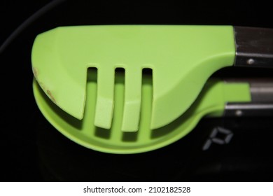 Green Plastic Spaghetti Tongs Close-up