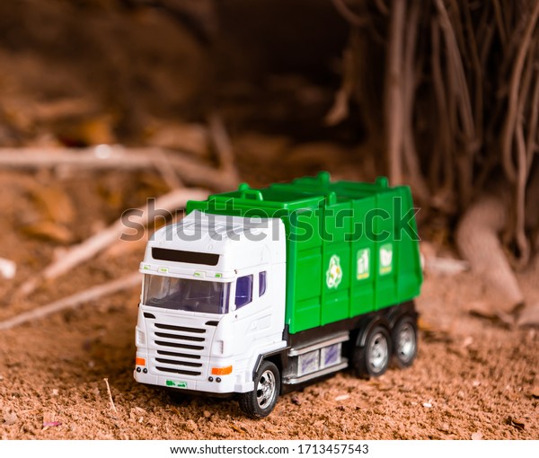 Green Plastic Toy Garbage Truck on Ground. Kids favorite\
toys 