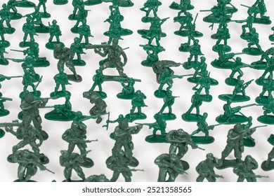 Green plastic toy soldiers on white background - Powered by Shutterstock