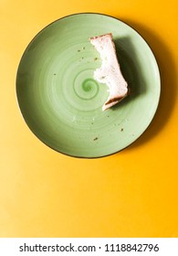 Green Plate Half Eaten Sandwich Bright Yellow Background Top View Copy Space