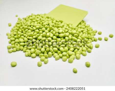 Green polymer masterbatch granules isolated on a white background are suitable for product catalog designs for industrial plastic company profiles