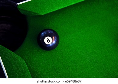 Green pool table with ball. Eight ball