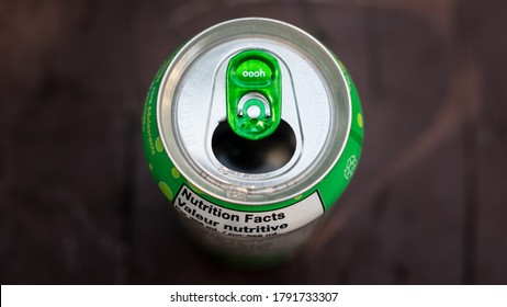 Green Pop Can Top Of Soda Lid Wallpaper. Open Cola Tab And Refreshing Drink On A Hot Summer Day